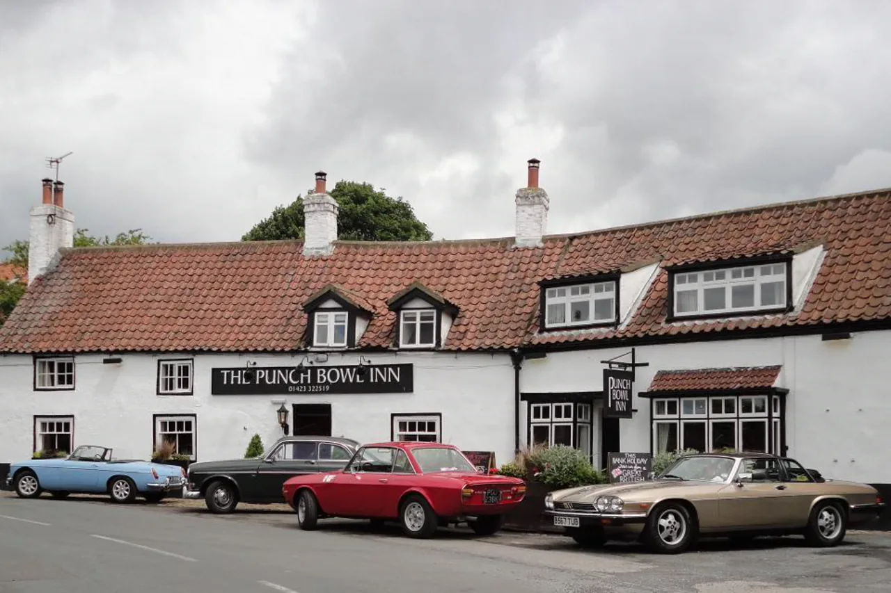 Classic cars lined up outside The Punch Bowl Inn