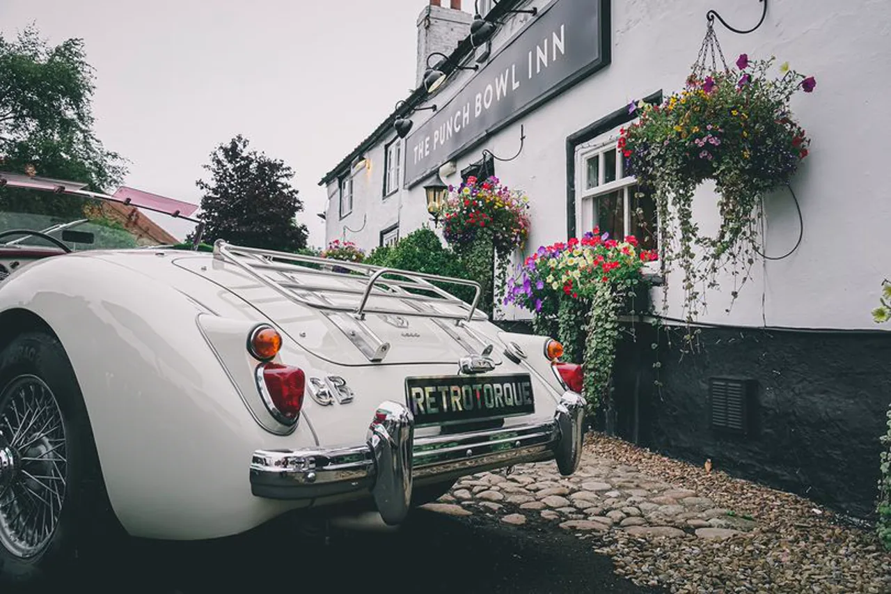White MGA outside The Punch Bowl Inn